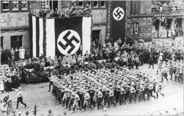 Battalions of Nazi street fighters salute Hitler during an SA parade through Dortmund. Germany, 1933